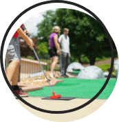 Family playing mini golf.
