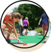 Kids playing mini golf.